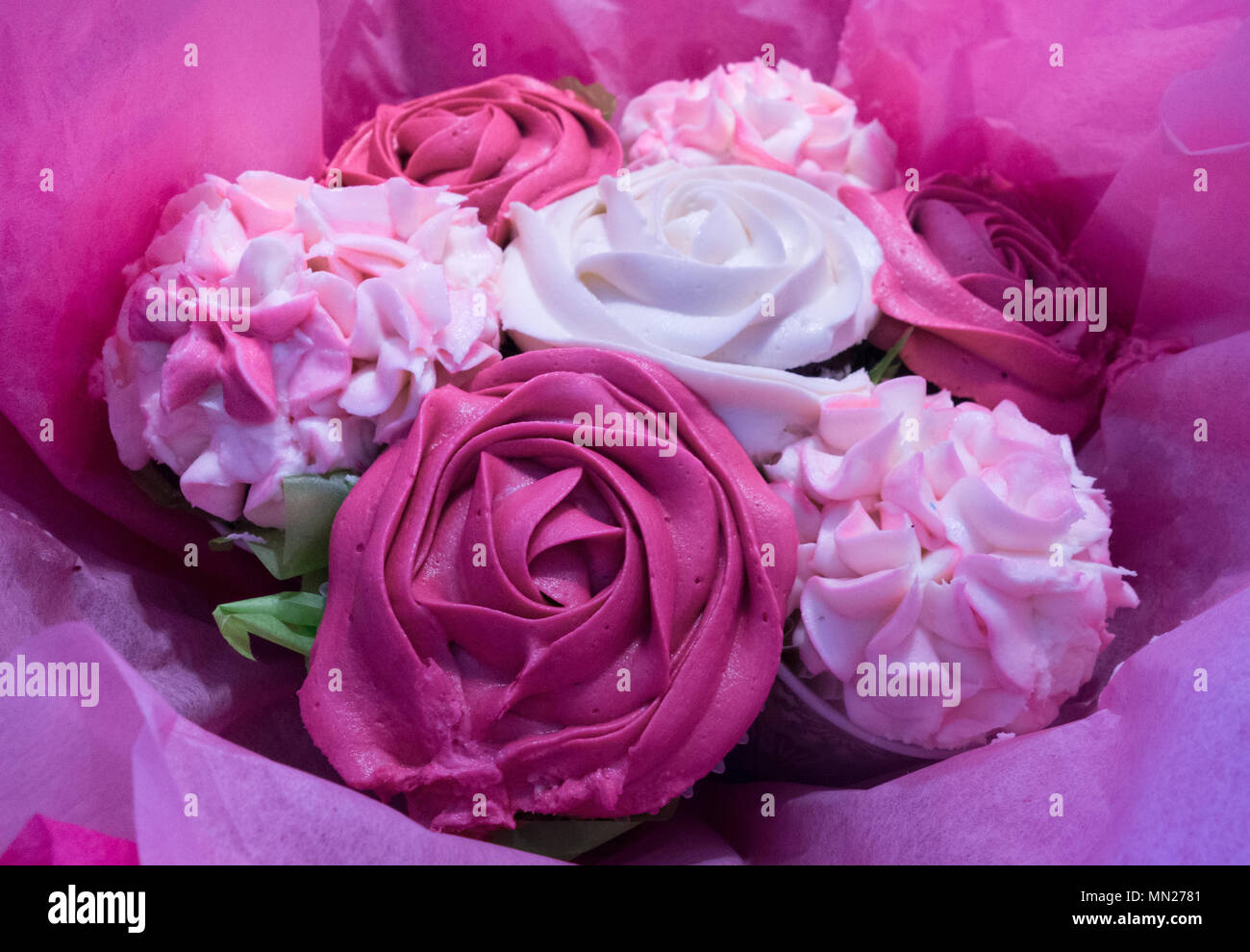 Beautiful pink ice cupcakes that look like a bouquet of roses and flowers Stock Photo