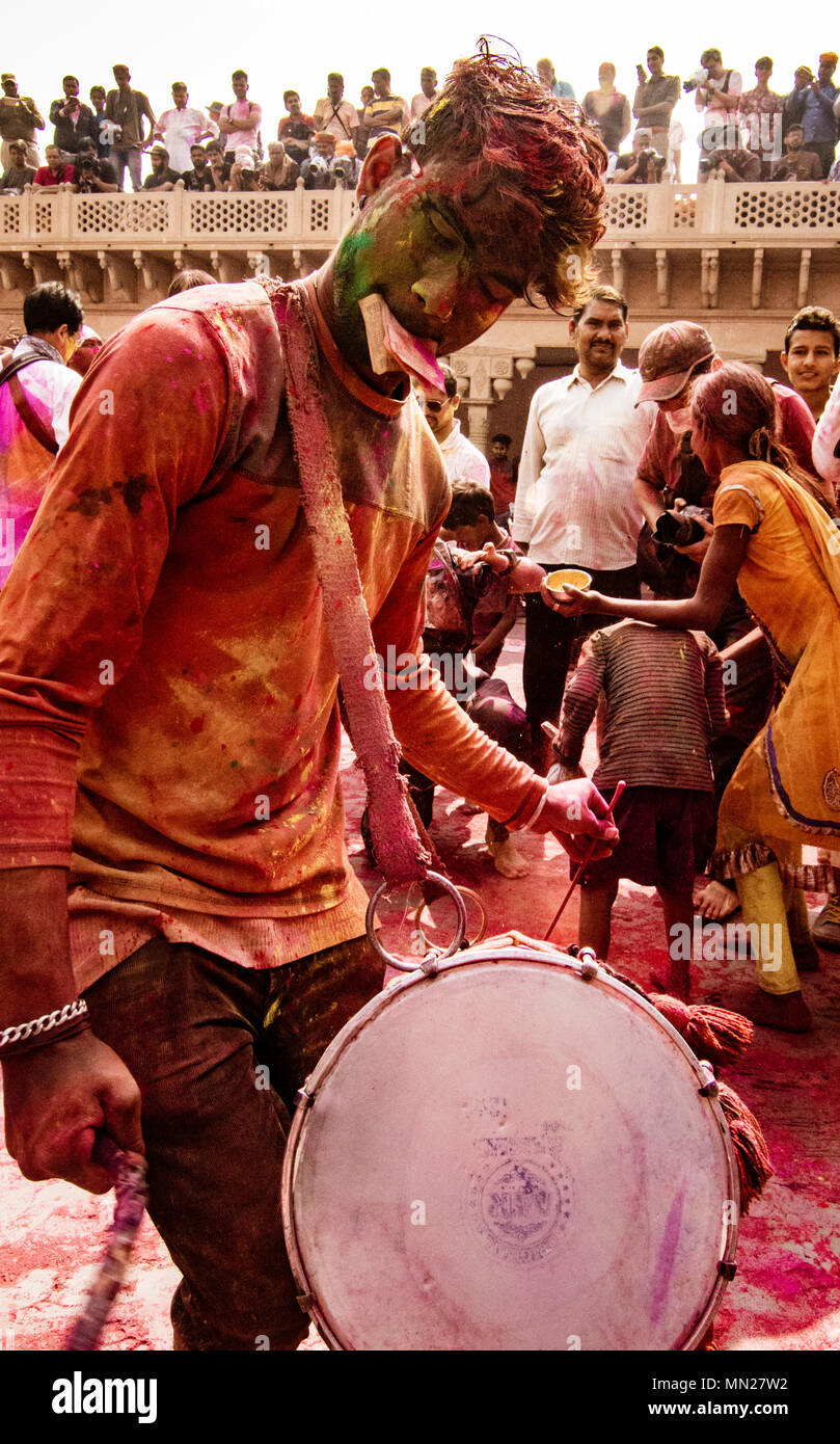 Nandgeon, India, Holi Festival, Feb 25, 2018 - Young man beats drum to provide music for Holi Festival in India Stock Photo