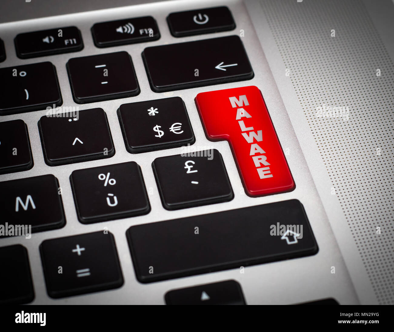 Red button with Malware word on the keyboard close-up. Stock Photo