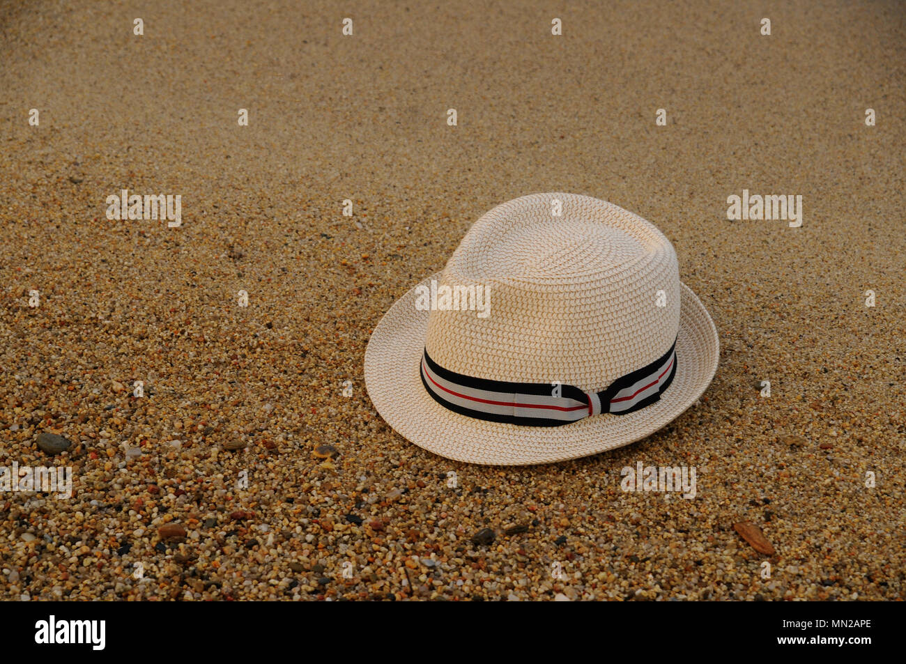 White hat on the beach sand in the summer Stock Photo Alamy