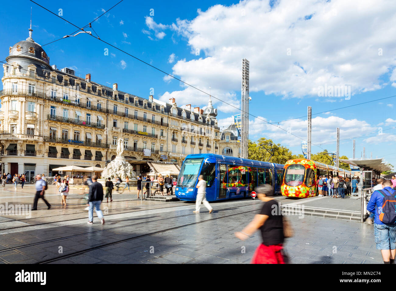 Montpellier (southern France): pedestrians, tram and Haussmann-style building facades in the square 'place de la Comedie', in the city centre Stock Photo
