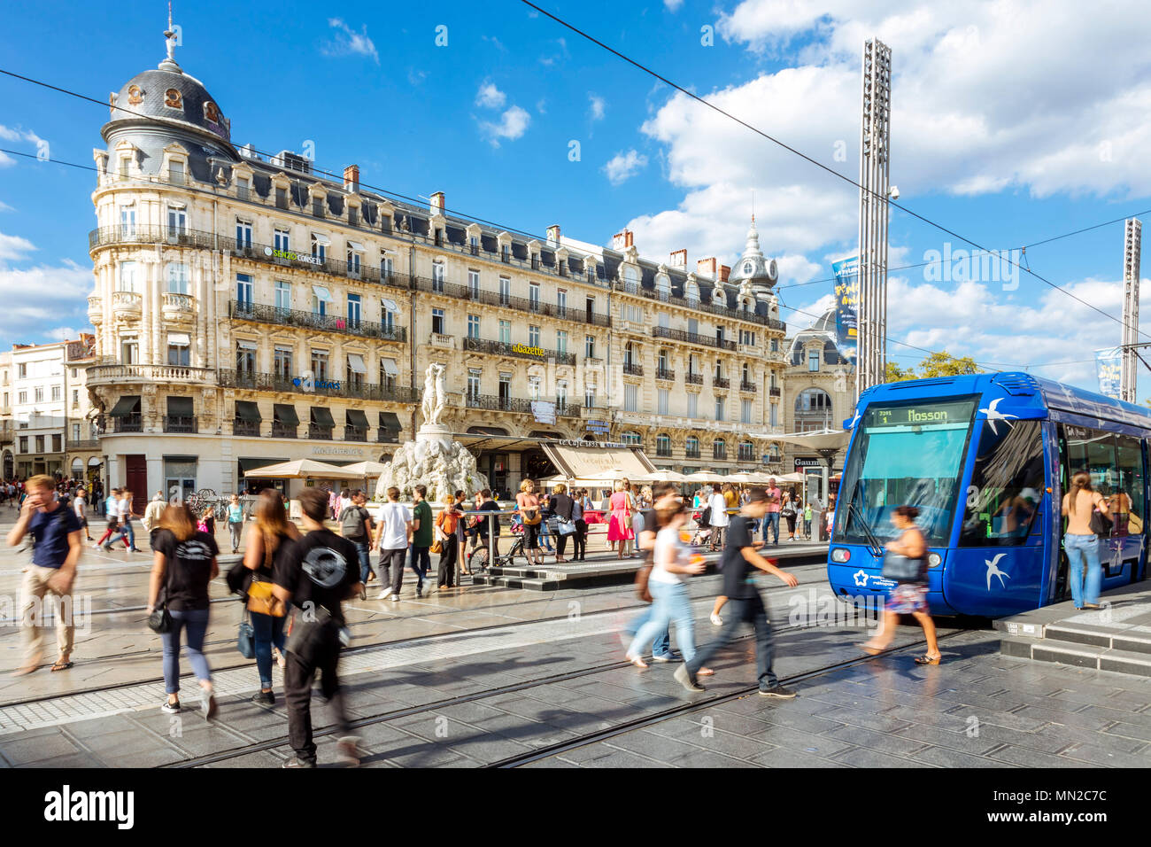 Montpellier (southern France): pedestrians, tram and Haussmann-style building facades in the square 'place de la Comedie', in the city centre Stock Photo