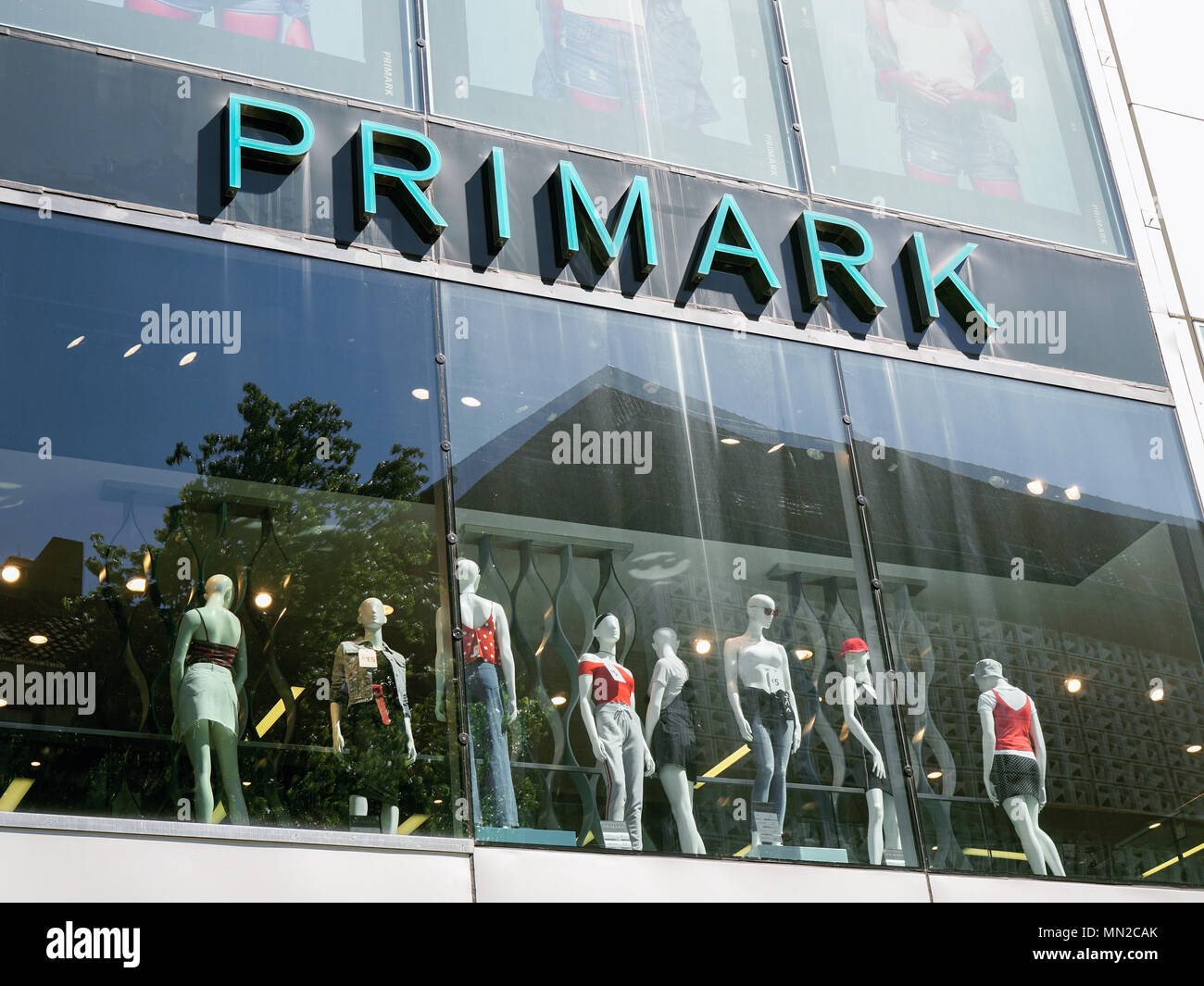 Hannover, Germany - May 7, 2018: Primark logo sign on storefront above shop window mannequins presenting their brand of fast fashion. Stock Photo