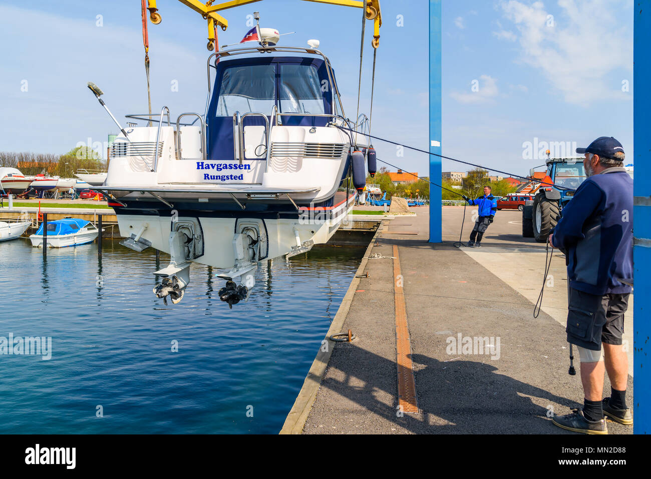 Hoganas, Sweden - April 30, 2018: Documentary of everyday life and place. The launching of a motorboat using a harbor crane. Stock Photo