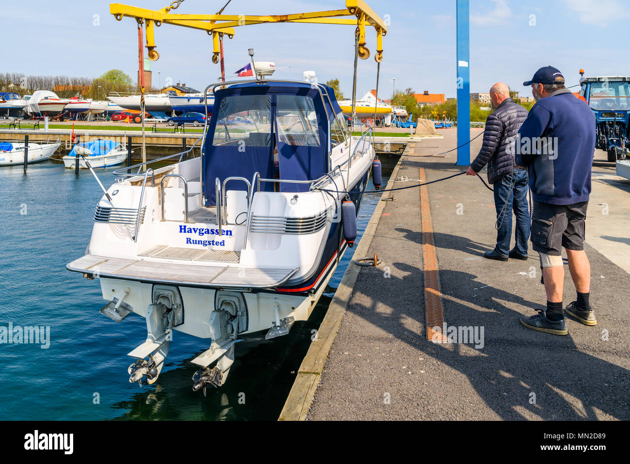 Hoganas, Sweden - April 30, 2018: Documentary of everyday life and place. The launching of a motorboat using a harbor crane. Stock Photo