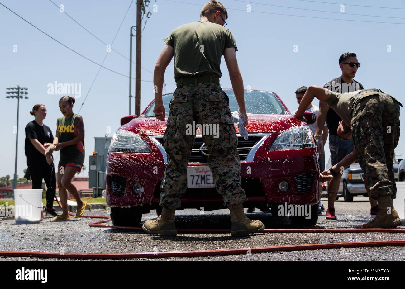 U.S. Marines with Combat Logistics Battalion 1, Combat Logistics Regiment 1, 1st Marine Logistics Group, work to detail a car during a fundraising car wash on Marine Corps Base Camp Pendleton, Calif. May 10, 2018, May 11, 2018. Funds from the car wash will be allocated towards the unit's Marine Corps ball, held annually on or around November 10 to celebrate the Marine Corps' birthday. (Marine Corps photo by Cpl. Desiree King). () Stock Photo