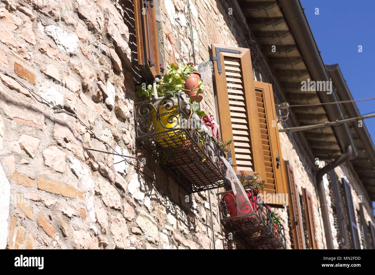 Plants under the window of a brick house (Collepino, Umbria, Italy Stock Photo Alamy