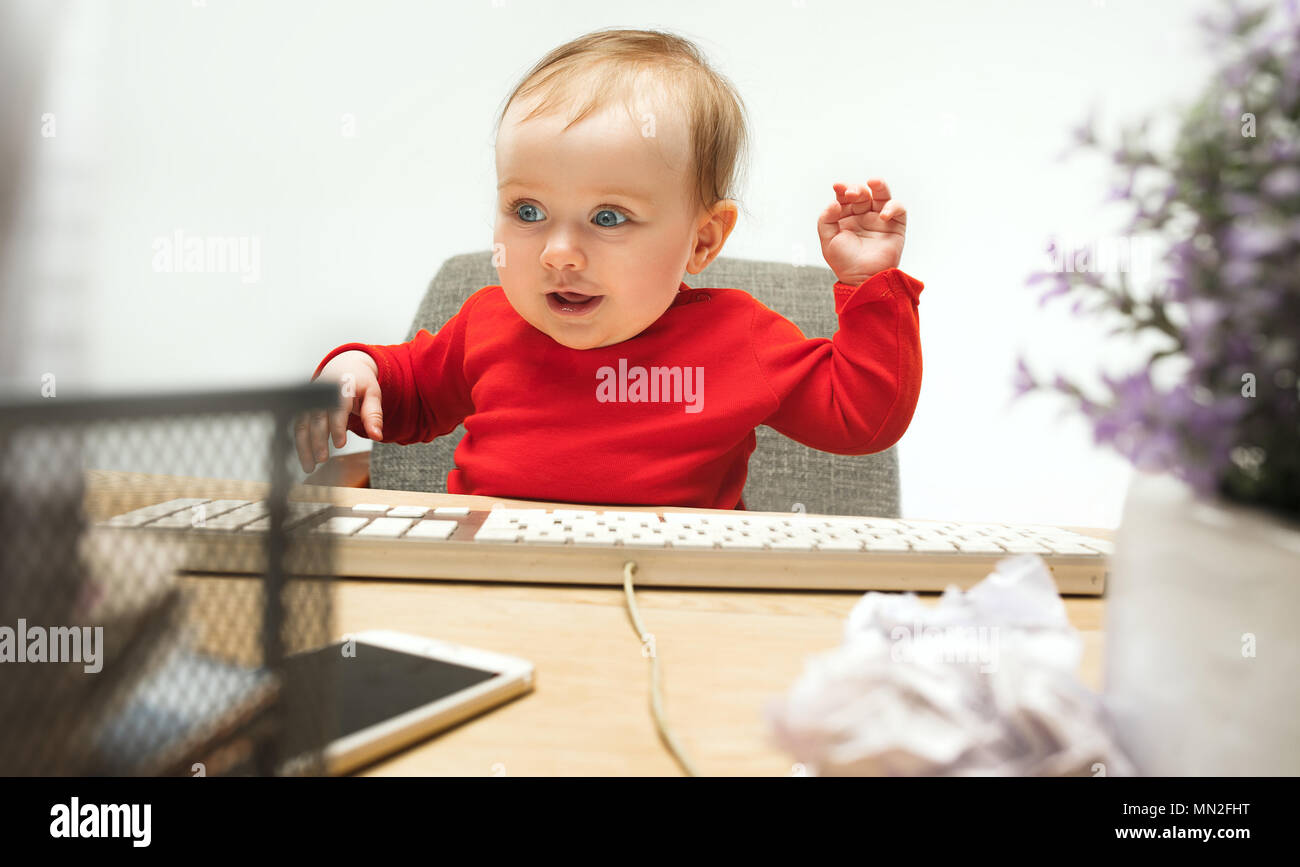 Happy child baby girl toddler sitting with keyboard of computer ...