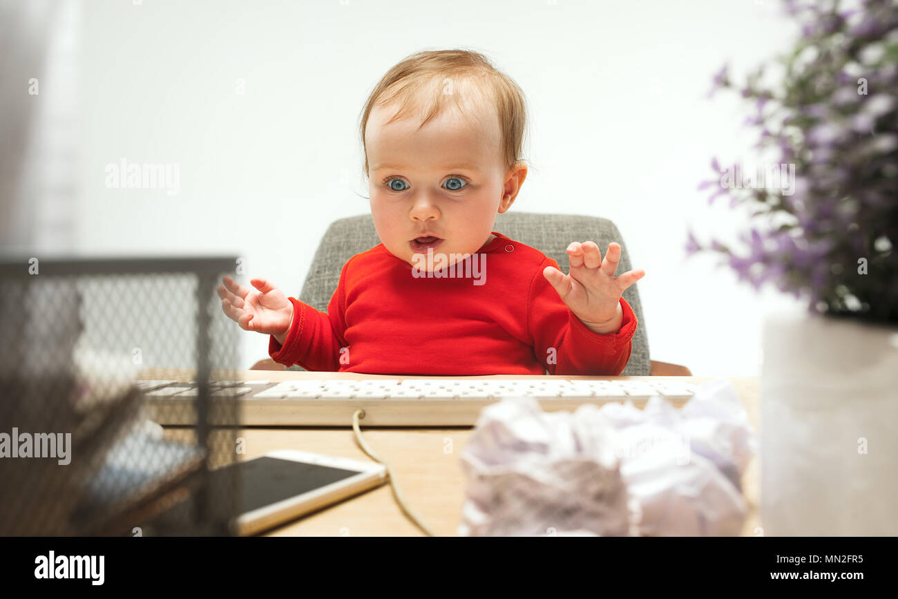 Happy child baby girl toddler sitting with keyboard of computer ...