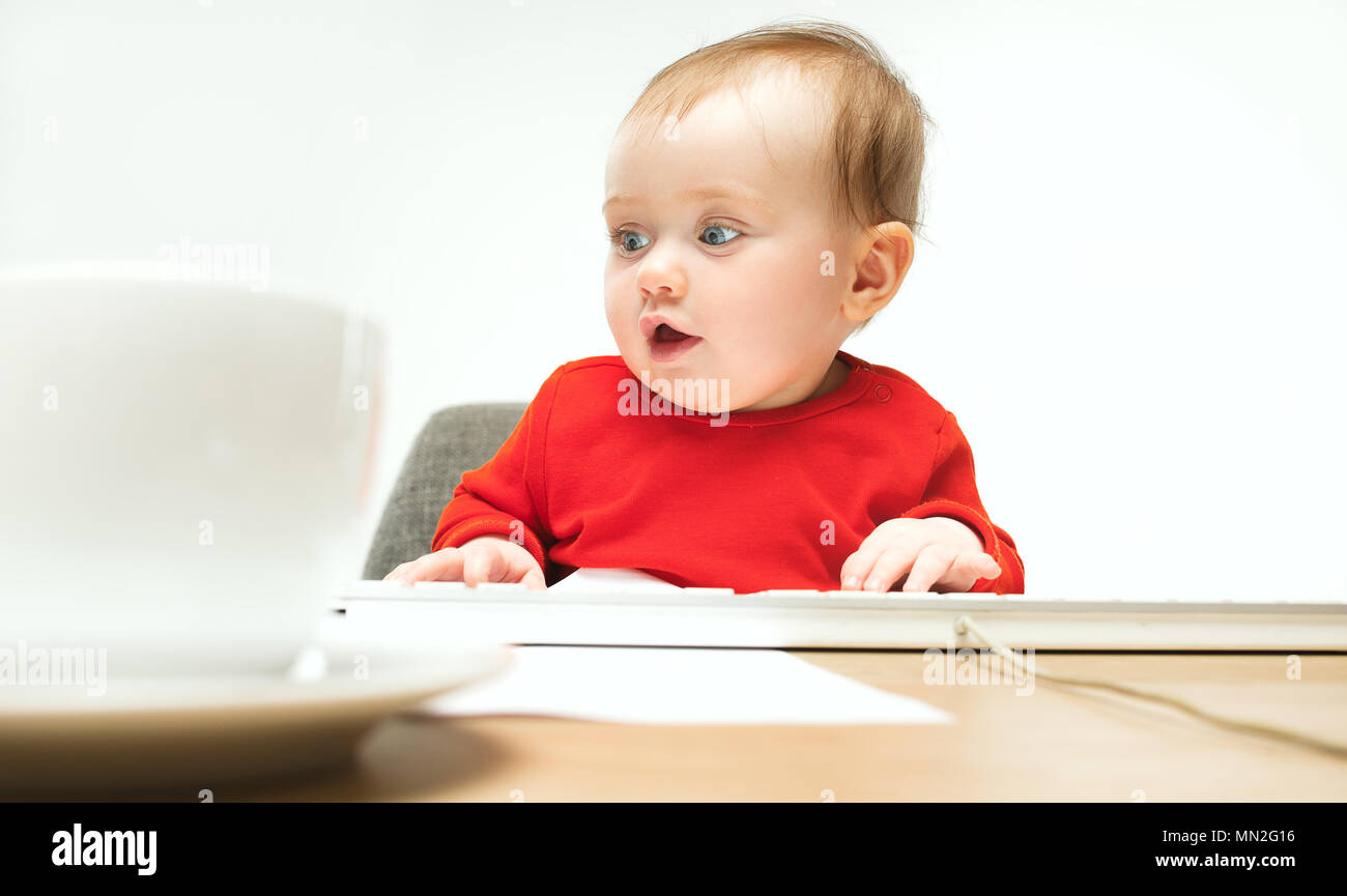 Happy child baby girl toddler sitting with keyboard of computer ...