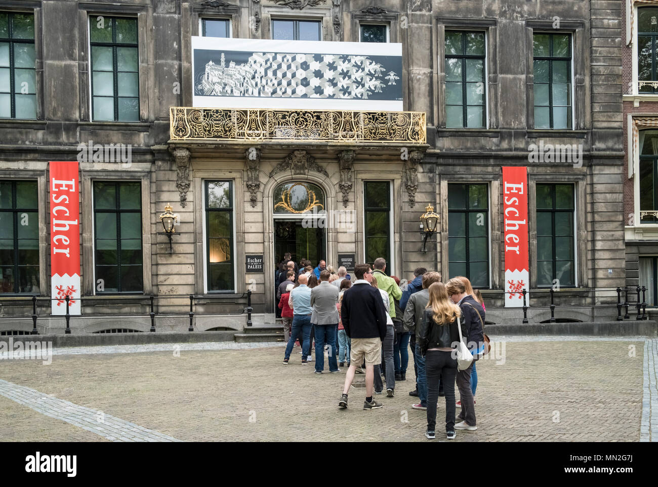 People queue outside the entrance to Escher in Het Paleis, to see works by Dutch artist M.C. Escher, Lange Voorhout Palace, The Hague, Netherlands. Stock Photo