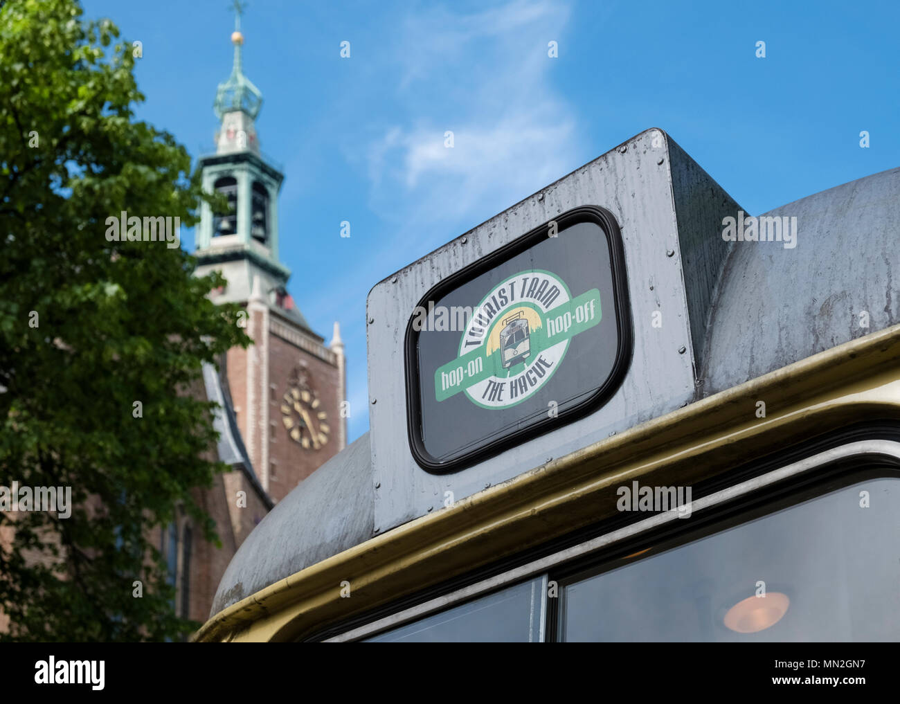 Close up of hop on, hop off, tourist tram transport outside the Grote Kerk, The Hague (Den Haag