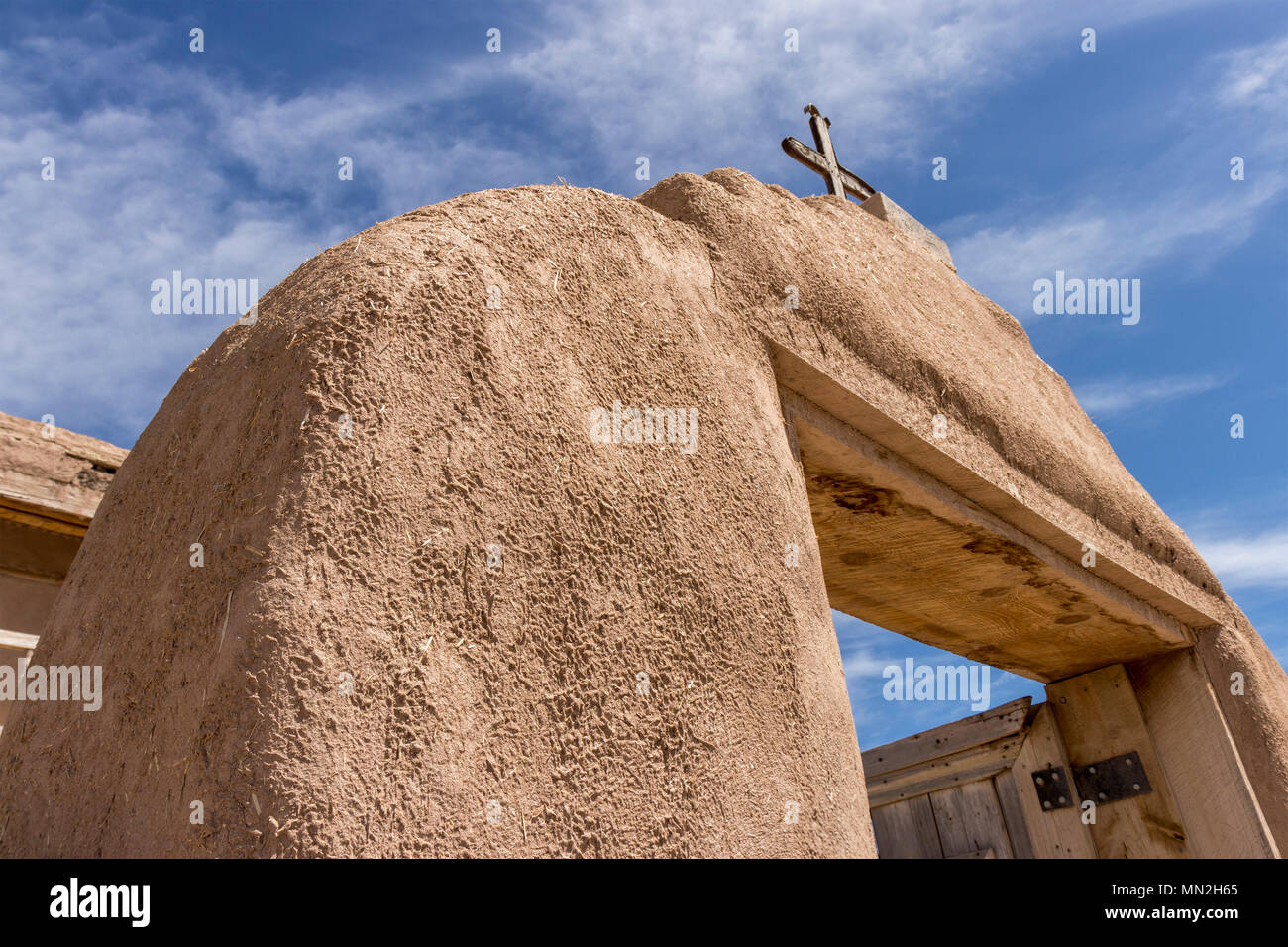 Adobe entryway to an old Spanish catholic church in a Native American Pueblo in springtime, Las Trampas, New Mexico, USA. Stock Photo