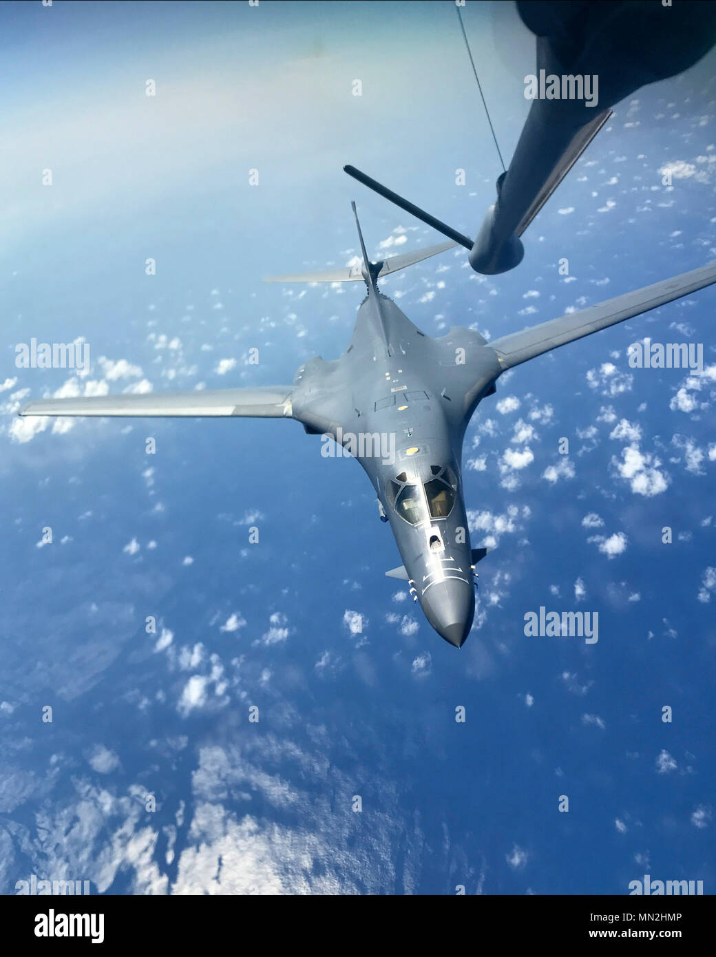 A U.S. Air Force B-1B Lancer assigned to the 37th Expeditionary Bomb Squadron, deployed from Ellsworth Air Force Base, S.D. to Andersen AFB, Guam, flies a training mission over the Pacific Ocean Aug. 16, 2017. During the mission two B-1s were joined by Japan Air Self-Defense Force F-15s in the vicinity of the Sankaku Islands. These training flights with Japan demonstrate the solidarity and resolve we share with our allies to preserve peace and security in the Indo-Asia-Pacific. (U.S. Air Force photo/Airman 1st Class Gerald R. Willis) Stock Photo