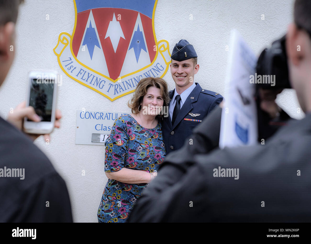 Air Force pilot 2nd Lt. Landon Moores and his mother Lorrie share a moment at Vance Air Force Base, Oklahoma, Aug. 18. Moores and his Specialized Undergraduate Pilot Training Class 17-13 classmates graduated from pilot training here during a morning ceremony. (U.S. Air Force photo by David Poe) Stock Photo