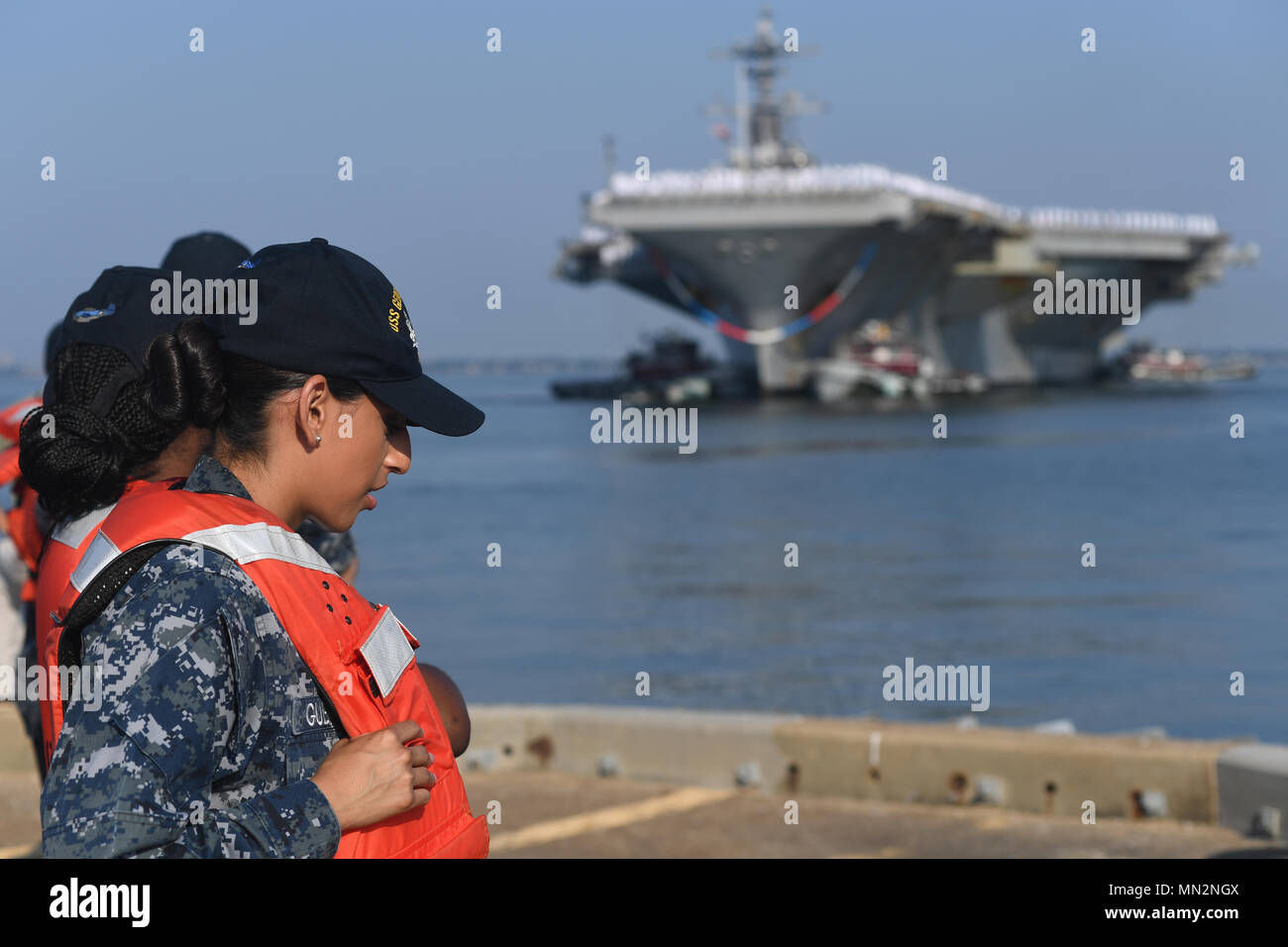170821-N-IC246-060 NORFOLK, Va. (Aug. 21, 2017) Boatswain's Mate 2nd Class  Jessica Guerra stands with line handlers as the USS George H.W. Bush (CVN  77) returns to Naval Station Norfolk. Bush arrives at
