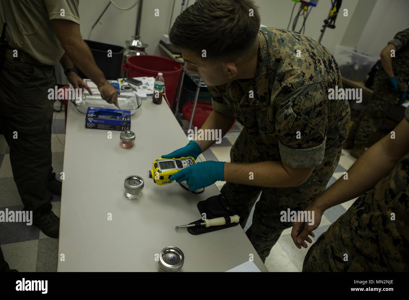 U.S. Marine Corps Sgt. Brandon Smith, a Chemical, Biological, Radiological,  Nuclear (CBRN) Defense Specialists, with Headquarters company, Headquarters  Battalion, 2nd Marine Division (2d MARDIV), test the potential of Hydrogen  (PH) levels of