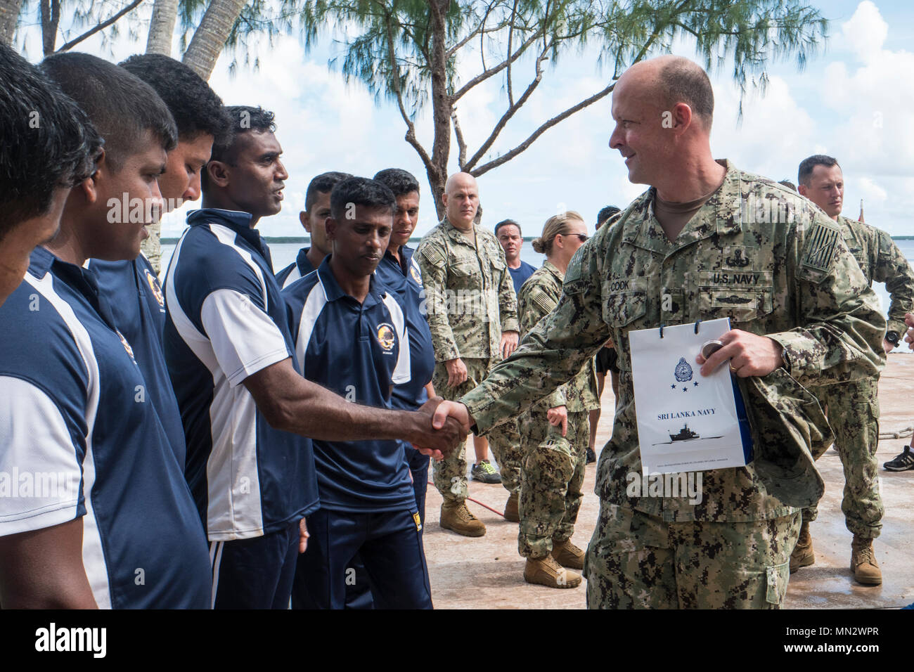Cmdr. Andrew Cook, assigned to Commander, Task Force (CTF) 75, greets Sri Lanka Navy (SLN) divers  during a Diving Subject Matter Expert Exchange (SMEE) at Naval Base Guam, Aug. 16, 2017. CTF-75 conducts SMEEs to strengthen the relationship and understanding between SLN and USN Divers through surface-supplied and SCUBA diving operations. (U.S. Navy Combat Camera photo by Mass Communication Specialist 1st Class Arthurgwain L. Marquez) Stock Photo