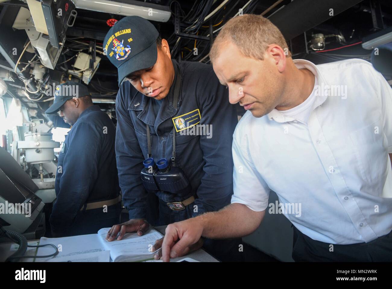 170822-N-GX781-233 SKAGERRAK STRAIT (Aug. 22, 2017) - Lt. j.g. John Hendricks, from Tampa, coordinates the track of the Arleigh Burke-class guided-missile destroyer USS James E. Williams (DDG 95) with a Danish pilot as the ship transits the Skagerrak Strait  Aug. 22, 2017.  James E. Williams, home-ported in Norfolk, is on a routine deployment to the U.S. 6th Fleet area of operations in support of U.S. national security interests in Europe. (U.S. Navy photo by Mass Communication Specialist 3rd Class Colbey Livingston/ Released) Stock Photo