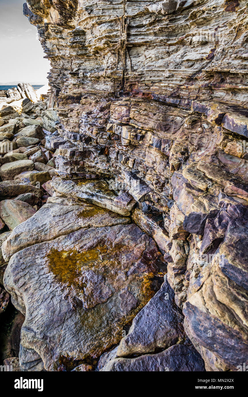 foot of the sandstone cliff face at Bouddi Point, Bouddi National Park, Central Coast, New South Wales, Australia Stock Photo