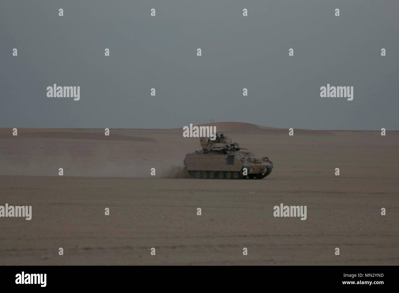 An M2a3 Bradley Fighting Vehicle Assigned To Bravo Company 2nd Battalion 7th Cavalry Regiment 3rd Armored Brigade Combat Team 1st Cavalry Division Maneuvers Through Udairi Range Complex During An Early Morning Attack