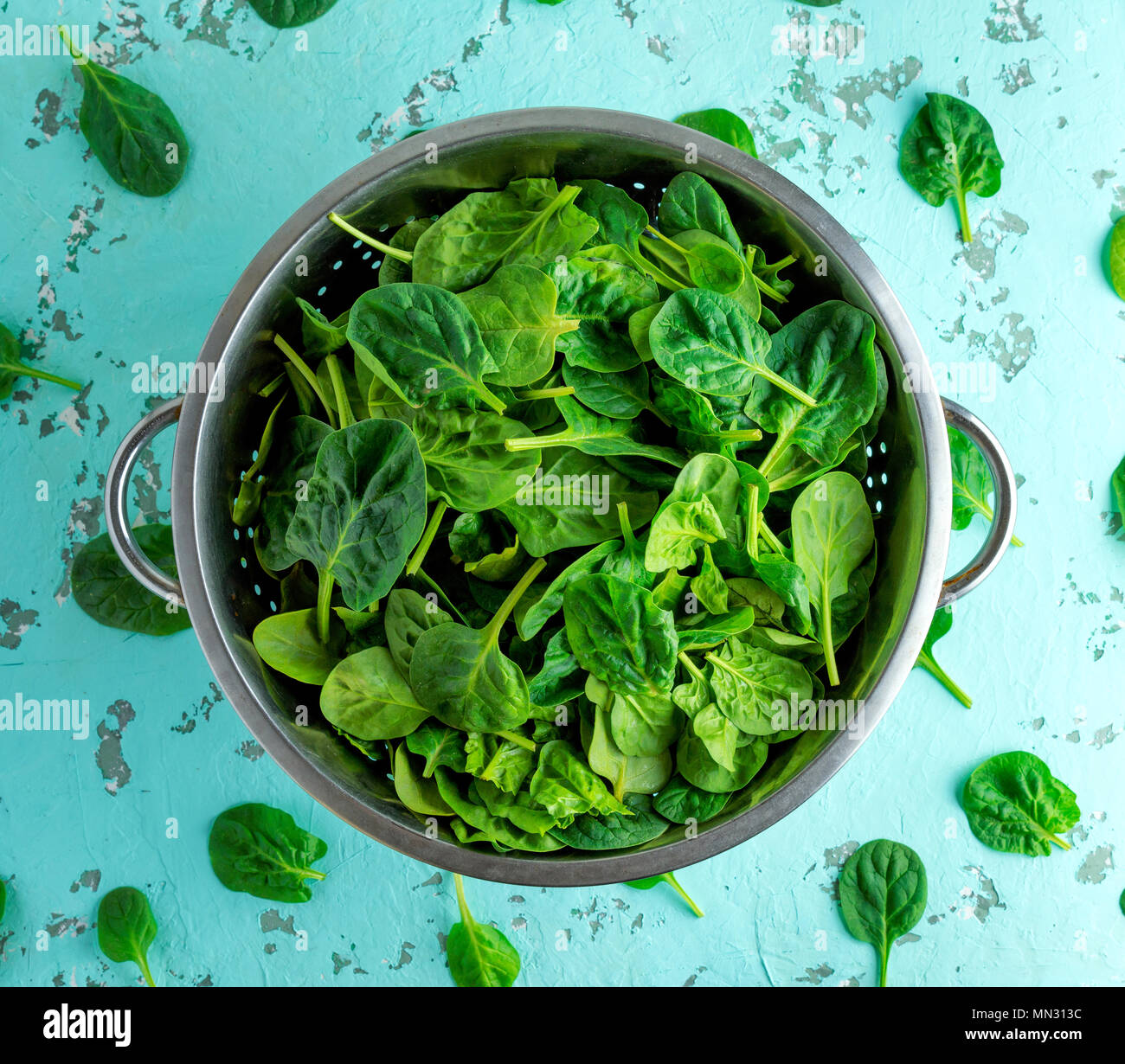 green spinach leaves in an iron colander, top view Stock Photo - Alamy