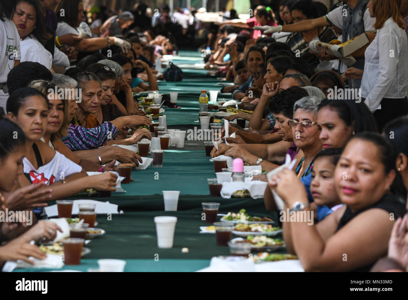 Female supporters seen enjoying their free food during the event. Presidential Candidate, Javier Bertucci, made an activity in Caracas to celebrate Mother's Day. In the activity they gave food to the women who attended, there was music and hairdressing service. Next Sunday, May 20, presidential elections will be held in Venezuela. In these elections, the opposition did not participate as it thinks that the electoral process is a fraud and there are no conditions to carry them out. The independent candidacies of Henri Falcón and Javier Bertucci will be measured against President Nicolas Maduro. Stock Photo