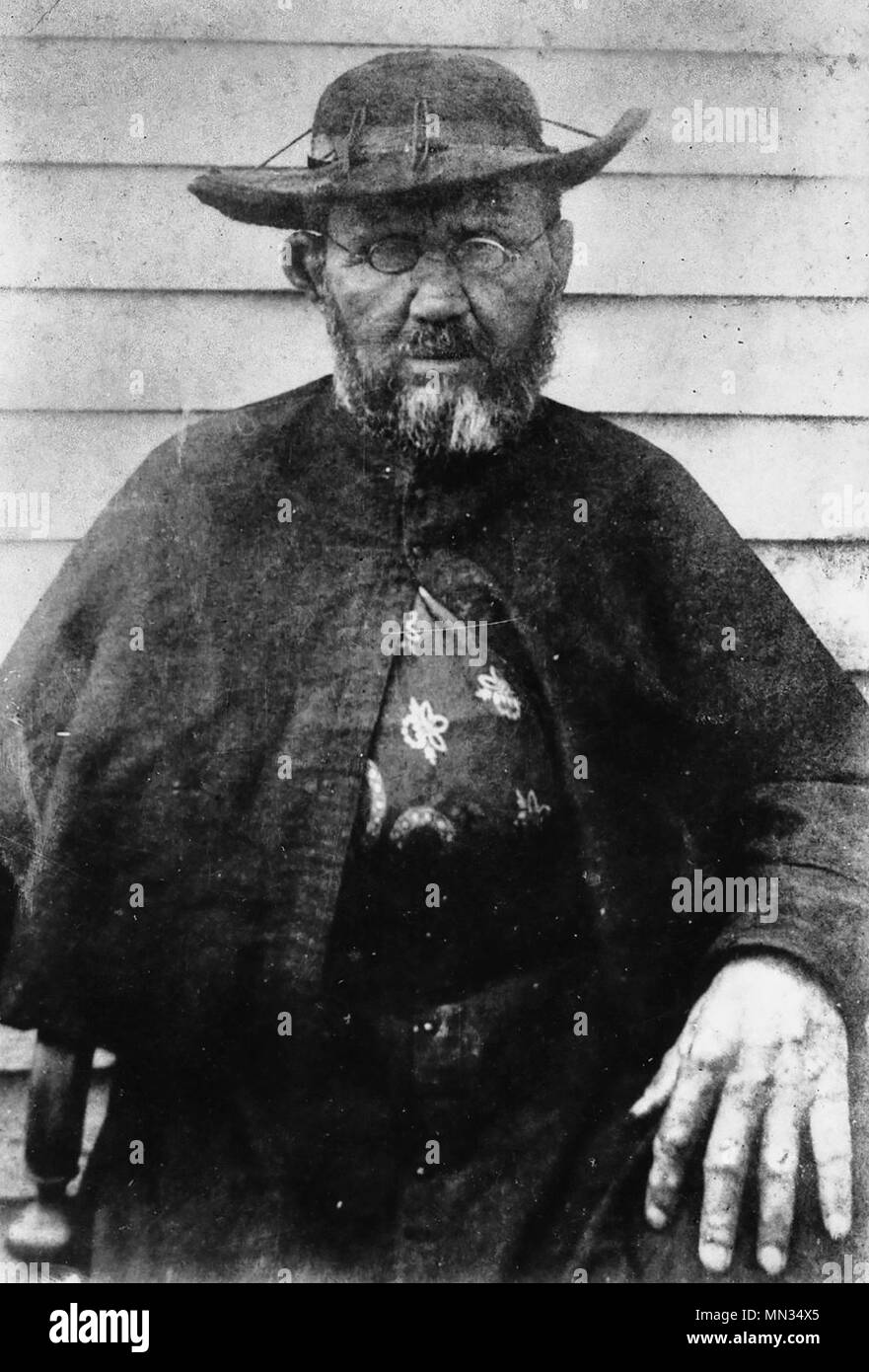 Father Damien, taken in 1889, either late February or March, weeks before his death by William Brigham at a side wall of the St. Philomena Catholic Church on the settlement. Stock Photo