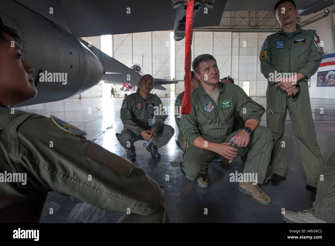 A U.S. Air Force pilot from the 25th Fighter Squadron examines a Philippine Air Force FA50