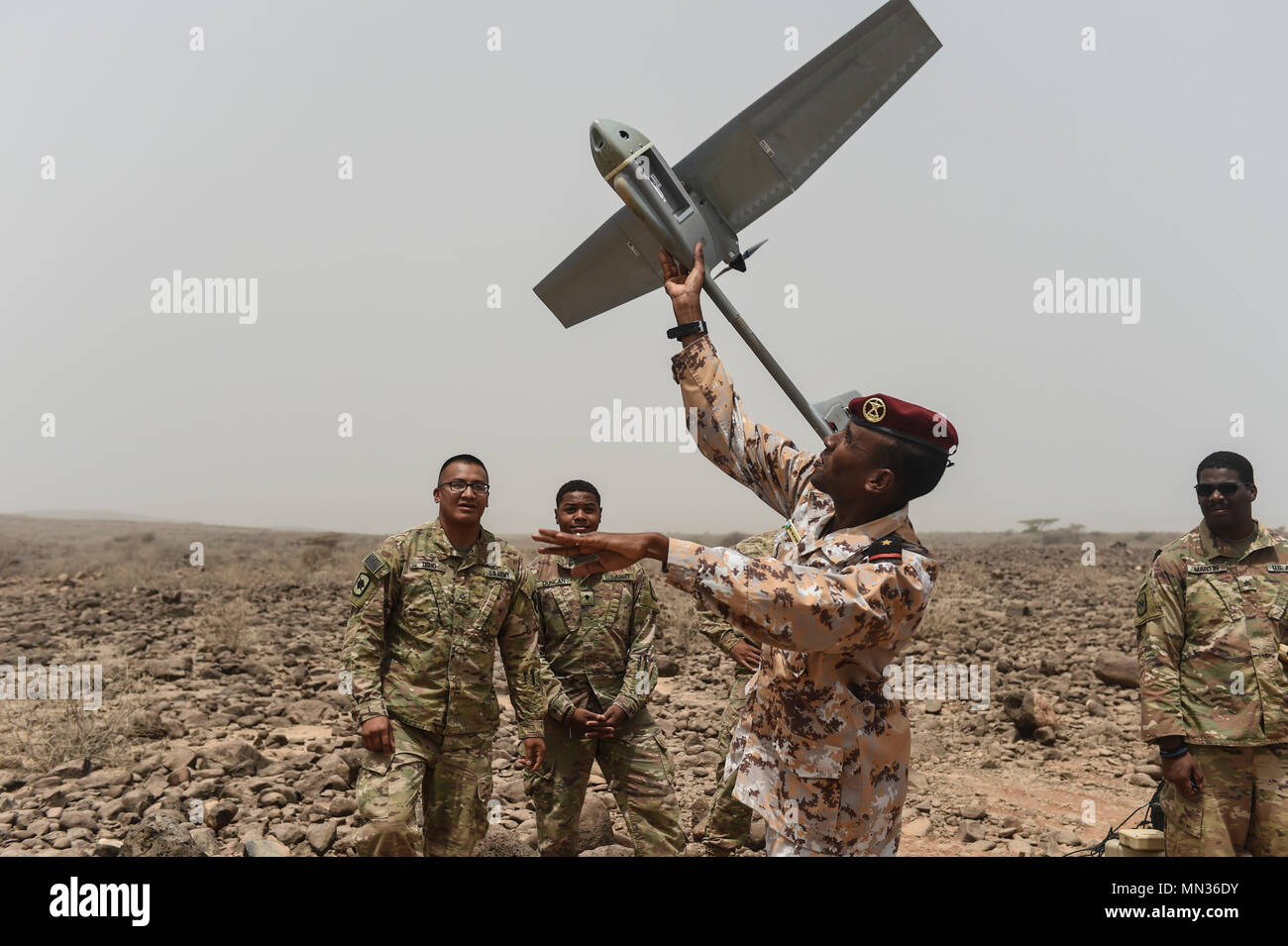 U.S. Army Soldiers assigned to the 1st Battalion, 153rd Infantry Regiment Task Force Warrior, an associated unit of Combined Joint Task Force - Horn of Africa, disassemble a Raven RQ-11 system during a demonstration in an airfield in southern Djibouti, Aug. 21, 2017. The demonstration was an effort to familiarize Djiboutian Armed Forces members with the unmanned aerial vehicle system, clear up confusion about the Raven RQ-11 and other RPAs, and show the safe operation of the Raven. (U.S. Air Force photo by Staff Sgt. Eboni Prince) Stock Photo