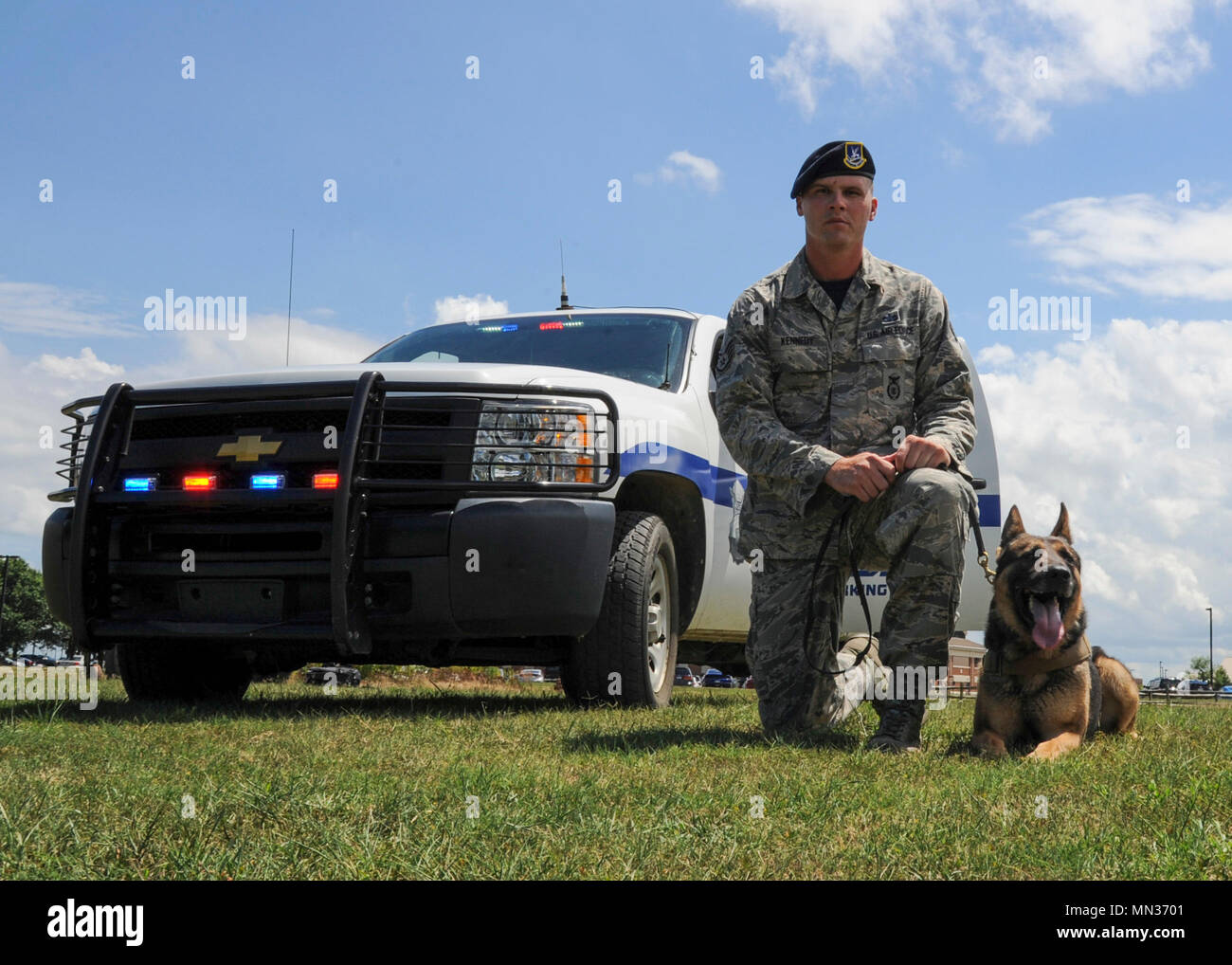 U.S. Air Force Staff Sgt. Jeffrie Kennedy, 633rd Security Forces Squadron military working dog handler, and his partner, Toni, 633rd SFS MWD, pose for a photo at Joint Base Langley-Eustis, Va., Aug. 4, 2017. Kennedy and Toni won first place in the “Iron Dawg” competition, hosted by Naval Air Station Oceana, Va., July 31, 2017. (U.S. Air Force photo/Airman 1st Class Anthony Nin Leclerec) Stock Photo