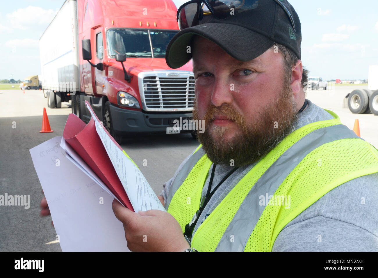 Matt Mikkola, a Federal Emergency Management Agency reserve receiving and distribution manager, inspects the bill of lading from a truck at JBSA Randolph auxiliary airfield, Seguin, Texas, August 30, 2017.  Mikkola, from Calumet Mich., is supporting disaster relief effort for a category 4 hurricane that had 130 mph winds as it made landfall, August 25, 2017.  Days after the hurricane reached the Texas, more than 50 inches of rain flooded the coastal region. (U.S. Air Force Photo by Tech. Sgt. Chad Chisholm/Released) Stock Photo
