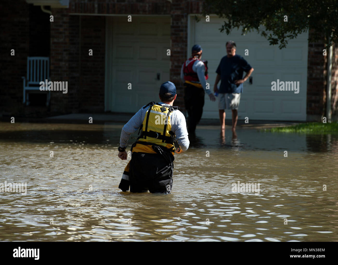 Members of Texas Task Force 1, coordinate the evacuation of a resident