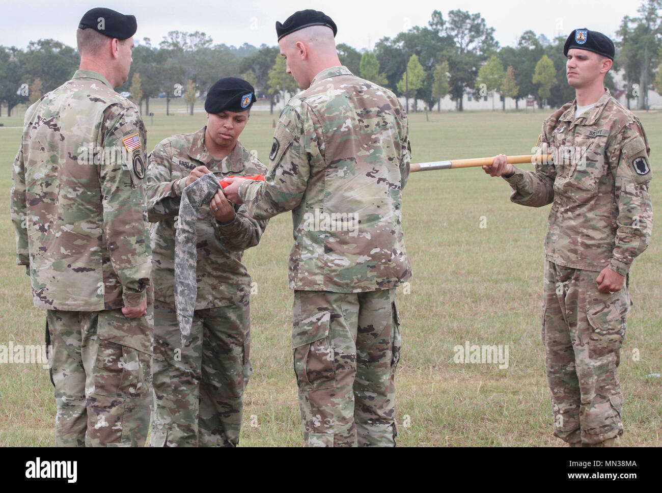 FORT GORDON, GA – Col. Chris O’Connor (left), commander, 35th Theater Tactical Signal Brigade, Capt. CPT Clayton E. Mosley (right), commander, 518th TIN Company and Master Sgt. Patrice Shuler (center), senior enlisted advisor, 518th TIN Company casing the company guidon during the 518th Deactivation Ceremony held 31 August at Barton Field’s Reviewing Stand. (U.S. Army photo by Sgt. Victor Everhart Jr.) Stock Photo