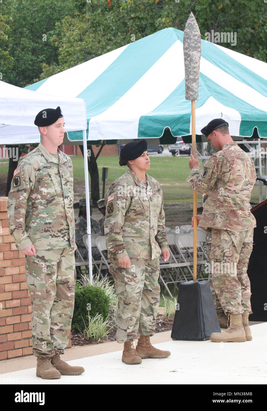 FORT GORDON, GA – Capt. CPT Clayton E. Mosley, commander, 518th TIN Company and Master Sgt. Patrice Shuler, senior enlisted advisor, 518th TIN Company stand together during the casing of the company guidon during the 518th Deactivation Ceremony held 31 August at Barton Field’s Reviewing Stand. (U.S. Army photo by Sgt. Victor Everhart Jr.) Stock Photo