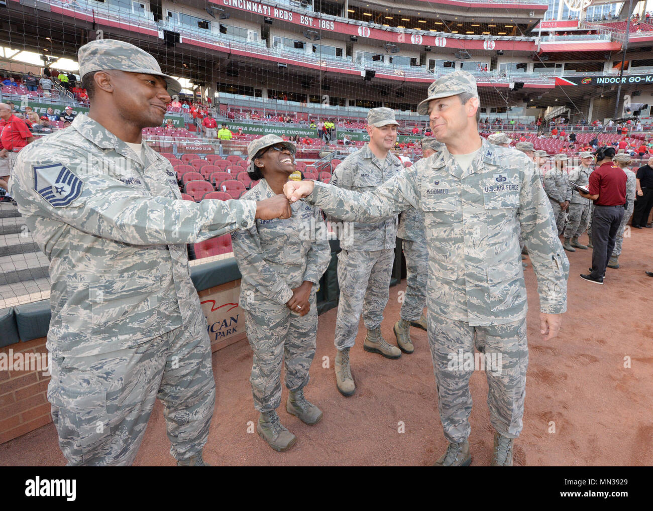 Colonel Bradley McDonald, 88th Air Base wing commander, with a fist bump congratulates Master Sergeant Nicholas Northam, Air Force Life Cycle Management Command base contracting A-Flight Non Commission Officer in Charge, for his superior job performance during pregame ceremonies at the Great American Ballpark, Cincinnati OH, August 25, 2017. The Cincinnati Reds baseball team sponsored the event to honor military members for service to the country. (U.S. Air Force Photo by Al Bright/Released) Stock Photo