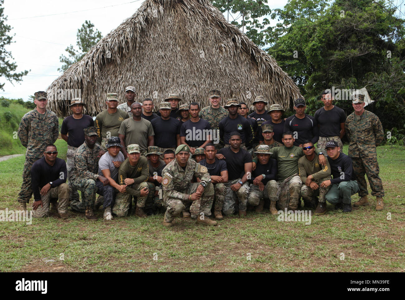 U.S. Marines with Mobile Training Team One, Special Purpose Marine Air-Ground Task Force - Southern Command, pose for a group photo with Panamanian service members from Servicio Nacional Aeronaval and other agencies as well as and distinguished guests at Agutin Santos Vinda Base, Panama, Aug. 25, 2017. The MTT is conducting a three-week course with the Panamanian service members composed of basic infantry tactics, marksmanship, and patrolling. The Marines and sailors of SPMAGTF-SC are deployed to Central America to conduct security cooperation training and engineering projects with their count Stock Photo