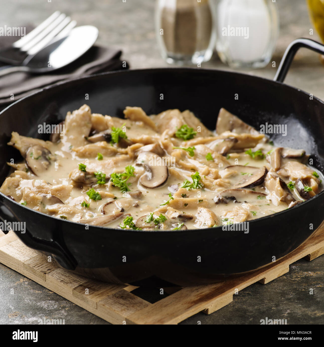 Vegan soy meat stripes and mushrooms in creamy sauce Stock Photo