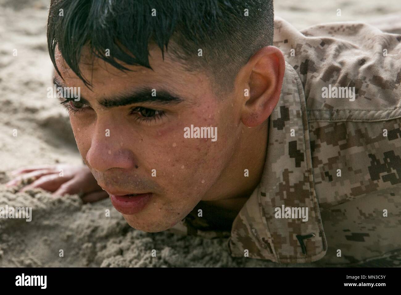 U.S. Marine Corps Pfc. Saul Vargas, a rifleman with 2nd Battalion, 4th Marine Regiment, assumes a pushup position before performing a simulated maneuver under fire during the fitness evaluation phase of the 1st Marine Division Infantry Super Squad Competition at Marine Corps Base Camp Pendleton, Cali., Aug. 30, 2017. The competition was designed to emphasize tactics, techniques, and procedures while nurturing the competitive natures’ and camaraderie of the infantry Marines within the division. (U.S. Marine Corps photo by Lance Cpl. Alexa M. Hernandez) Stock Photo