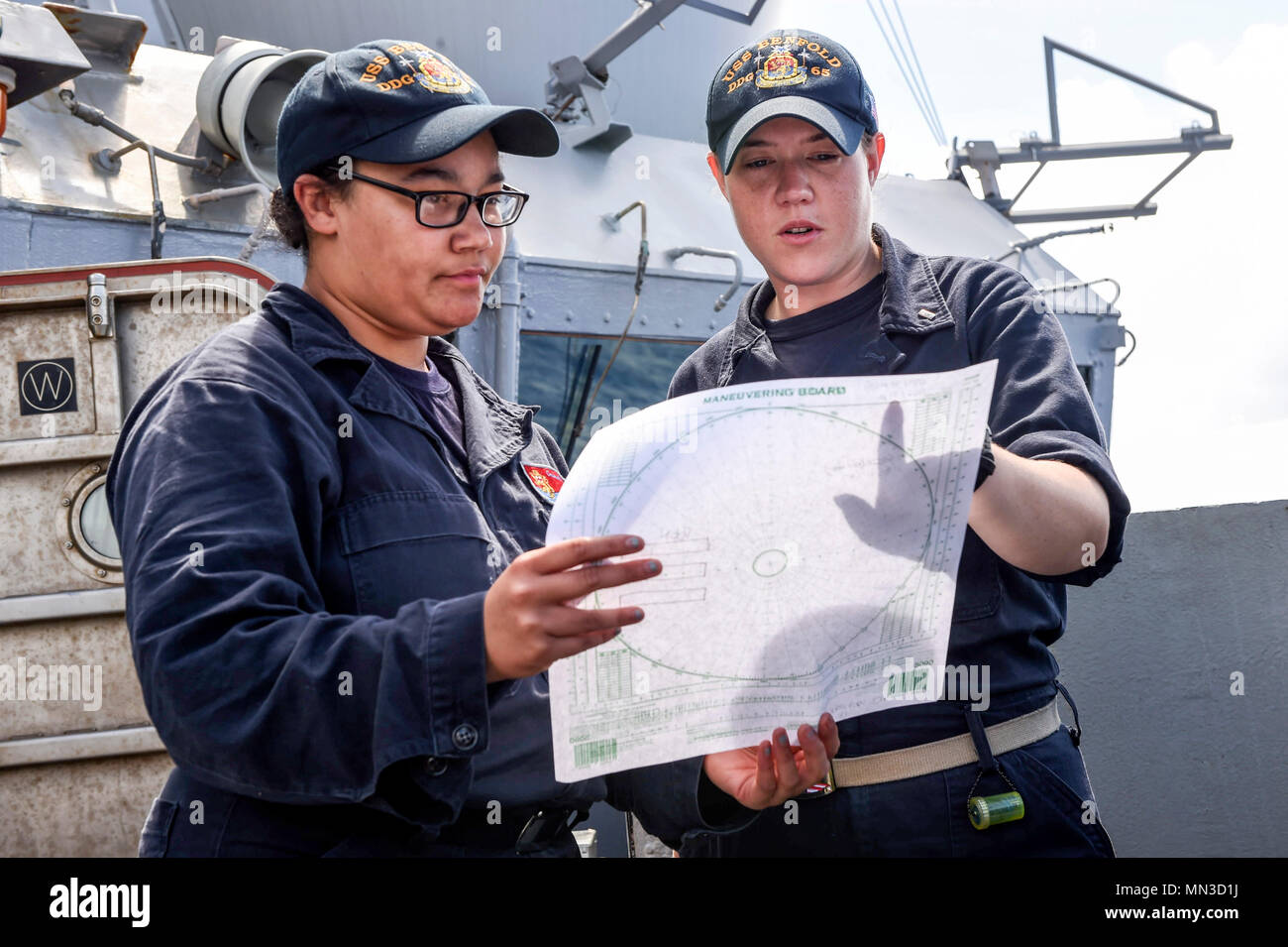 170827-N-RB168-051 PHILLIPINE SEA (Aug. 27, 2017) Lt. j.g. Emily Hannon, right, a native of Knoxville, Tennessee, and Operations Specialist Seaman Amanda Mack, a native of Lexington, Kentucky, discuss maneuvering considerations during an anti-submarine warfare exercise aboard the Arleigh Burke-class guided-missile destroyer USS Benfold (DDG 65) as part of Pacific Griffin 2017. Pacific Griffin is an exercise between the U.S. and Republic of Singapore navy (RSN), representing the enhanced capabilities of both navies to operate and work together to ensure maritime security and stability. (U.S. Na Stock Photo