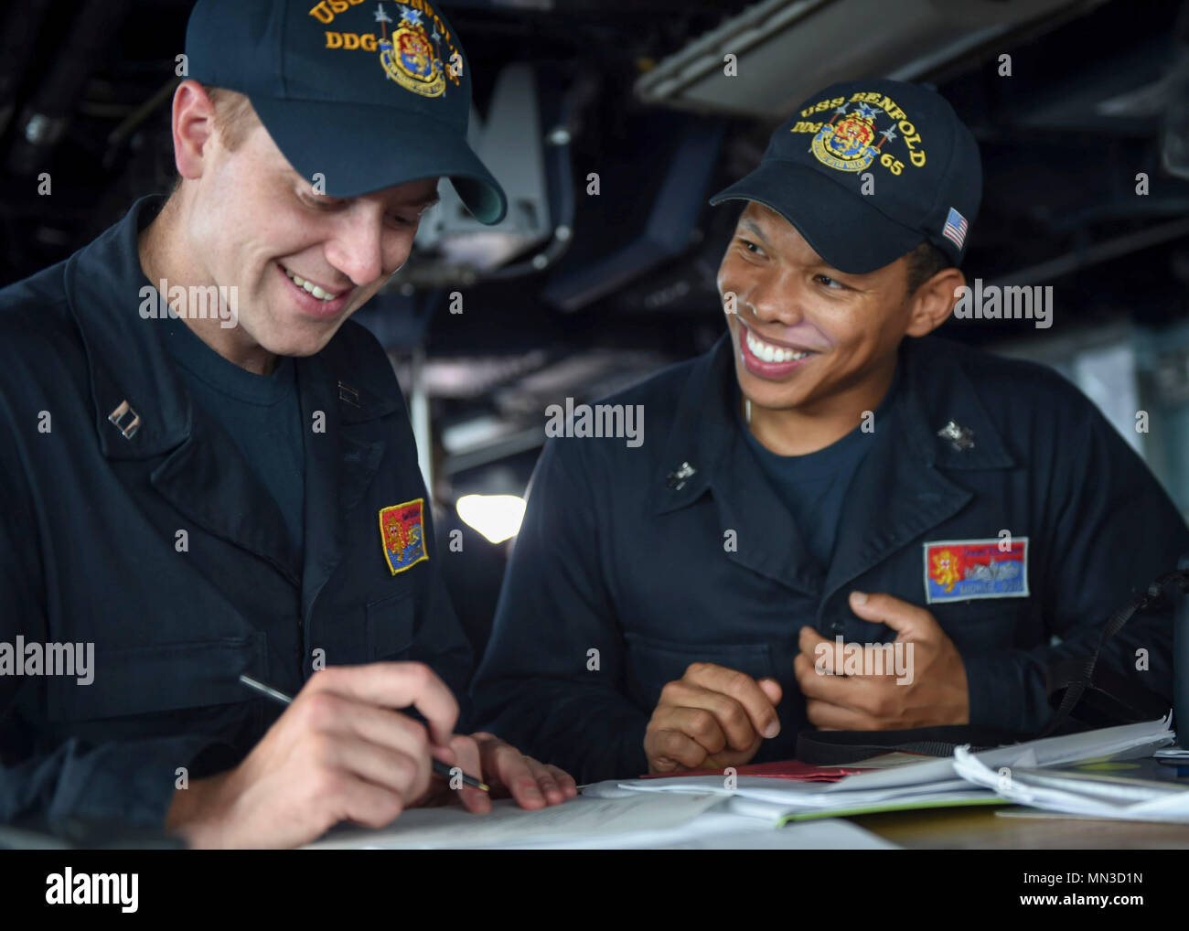 170829-N-RB168-072 GUAM (Aug. 29, 2017) Lt. Lloyd Mustin, a native of Richmond, Virginia and Yeoman 1st Class Michael Boyd, a native of Cleaton, Kentucky, discuss the plan of the day and review the procedures and requirements for an underway replenishment at sea aboard the Arleigh Burke-class guided-missile destroyer USS Benfold (DDG 65) during Pacific Griffin 2017. Pacific Griffin is an exercise between the U.S. and Republic of Singapore navy (RSN), representing the enhanced capabilities of both navies to operate and work together to ensure maritime security and stability. (U.S. Navy photo by Stock Photo