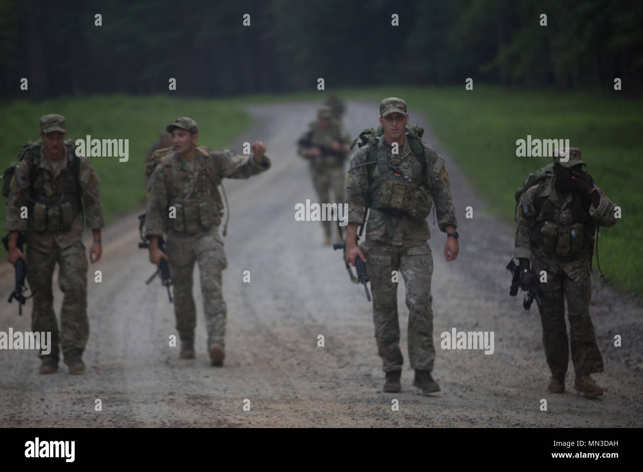 U.S. Soldiers, assigned to 2nd Battalion, 75th Ranger Regiment, participate in the 12-mile ruck march event during the Ordnance Crucible at Fort Pickett, Va., Aug. 24, 2017. The U.S. Army Ordnance Crucible is a three-part competition, comprised of the Ammunition Transfer Holding Point, Combat Repair Team, and Explosive Ordnance Disposal, which is designed to test Soldiers’ teamwork and critical thinking skills.  (U.S. Army photo by Pfc. Dracorius White) Stock Photo