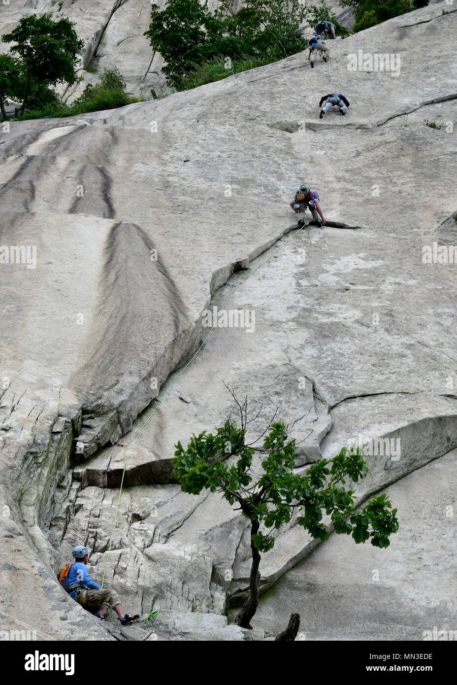 Members assigned to the 51st Civil Engineer Squadron Explosive Ordnance Disposal shop, climb a mountain during a Mountain Mobility Course at Bhukansan National Park, City of Seoul, Republic of Korea on August 30, 2017. The course allowed members to learn t procedures and techniques that go into mountain climbing. (U.S. Air Force photo by Staff Sgt. Franklin R. Ramos/Released) Stock Photo