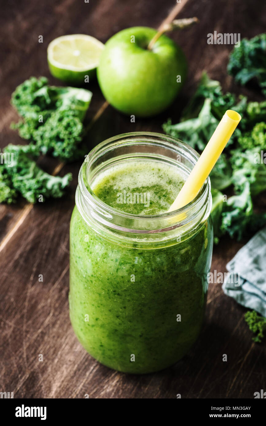 Green detox smoothie or juice in glass bottle. Smoothie with kale, apple, lime and broccoli. Concept of healthy lifestyle, healthy eating, vegan and v Stock Photo