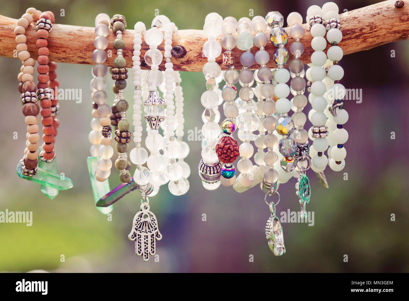 Natural bead bracelets hanging on natural branch Stock Photo Alamy