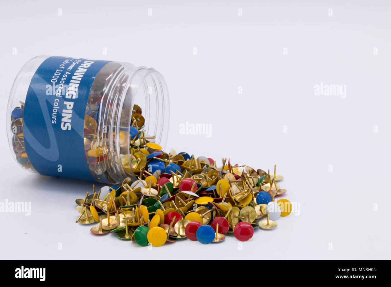 Pile of colourful drawing pins / thumb tacks on a white background Stock Photo