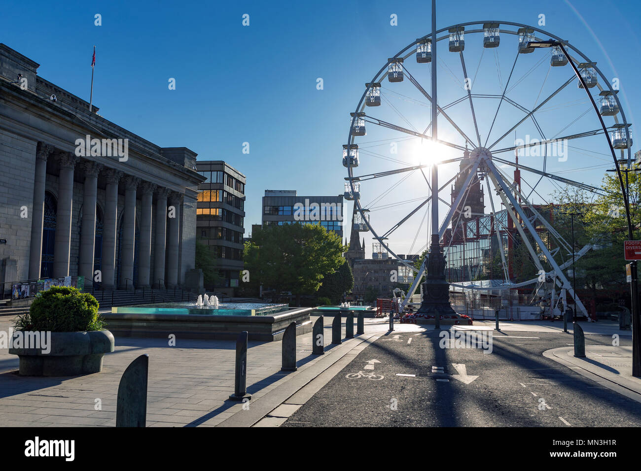 Sheffield City Hall and a temporary observation wheel on a sunny day in May, with completely blue skies and no clouds. Sheffield, South Yorkshire, UK. Stock Photo