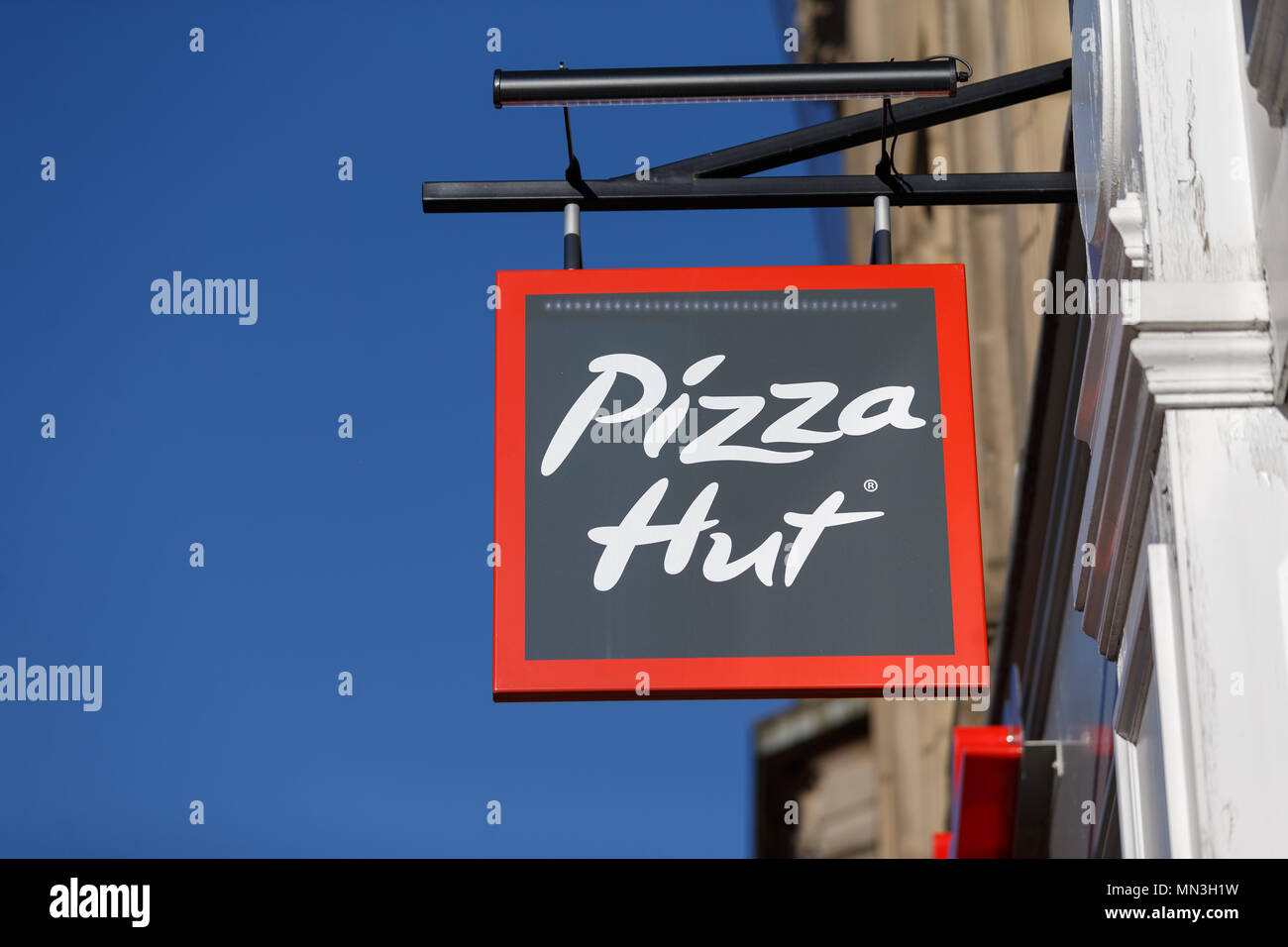 A high street branch of pizza restaurant chain Pizza Hut in the United Kingdom. / Pizza Hut logo, Pizza Hut sign. Stock Photo