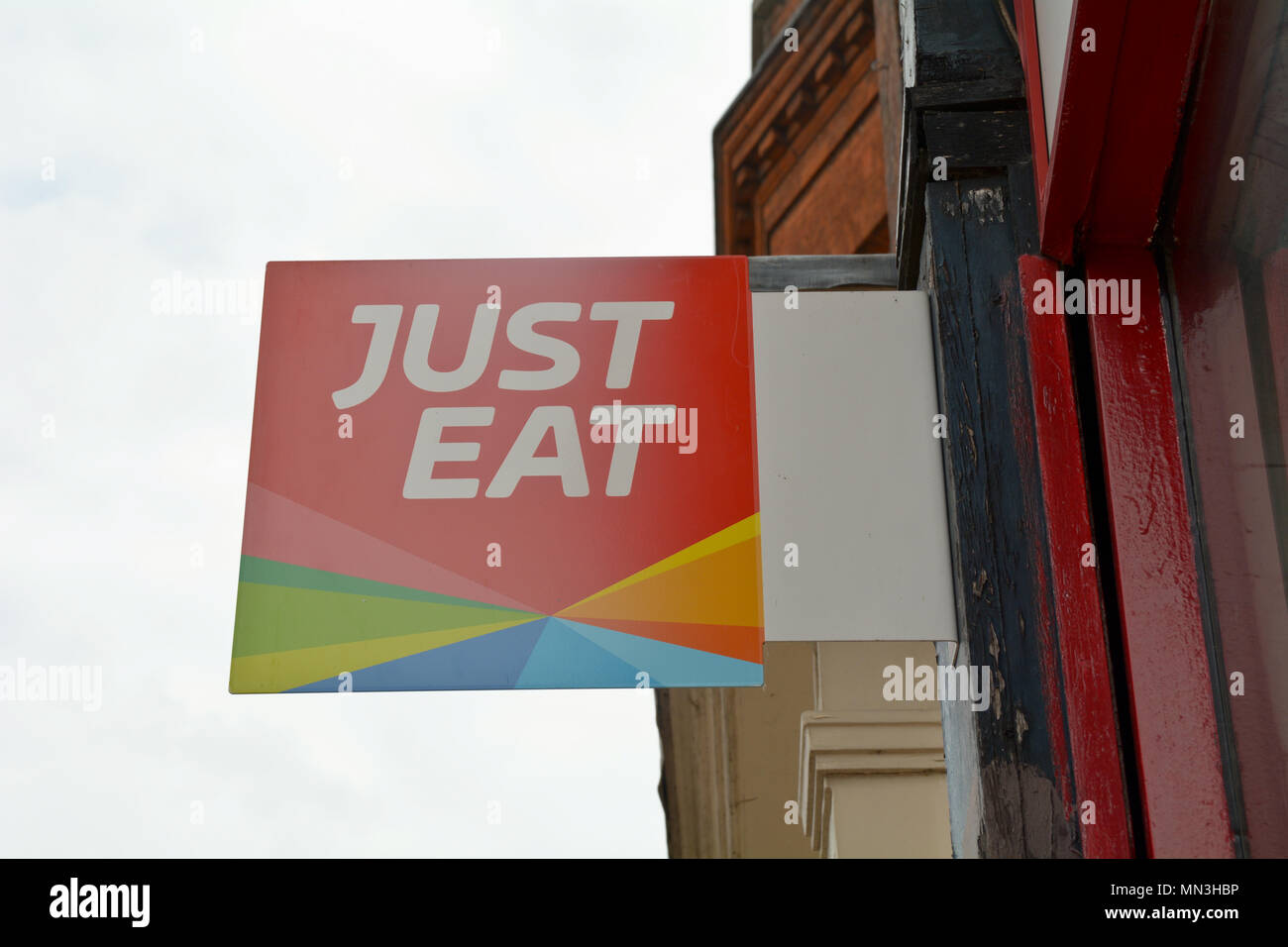 Just Eat sign outside fast food restaurant Stock Photo