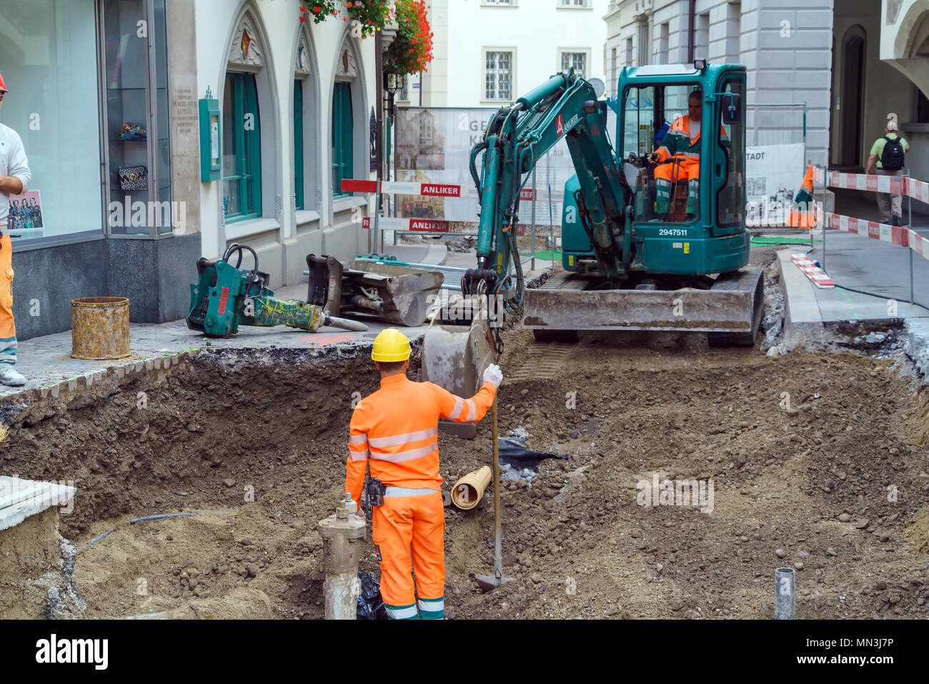 Construction workers in orange uniforms hi-res stock photography and ...